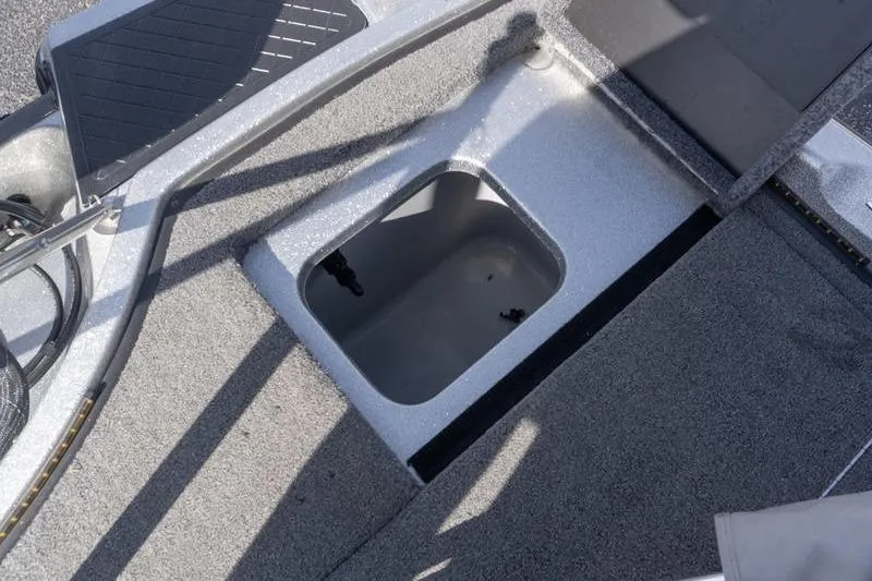 Slide: The Image of 2012 Triton 190 SE boat storage compartment with gray interior and textured flooring. - 21