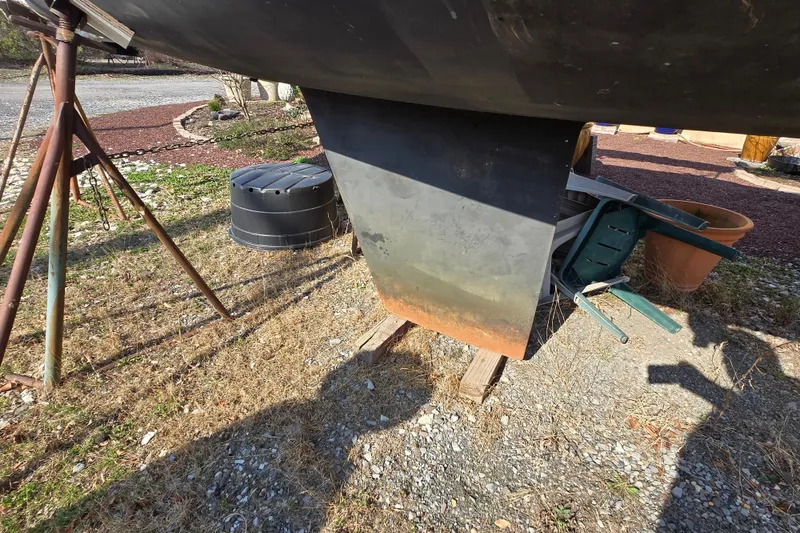 Slide: The Image of 1983 Tillotson-Pearson 21 Freedom sailboat keel on dry land with support stands. - 6