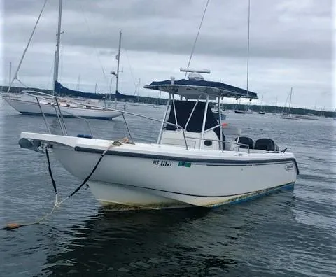 Slide: The Image of 1999 Boston Whaler Outrage 26 boat on calm water. - 2