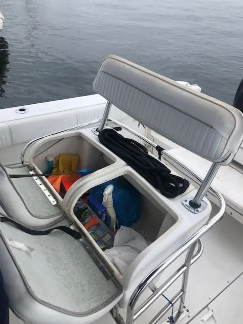 Slide: The Image of 1999 Boston Whaler Outrage 26 with open seat storage on deck. - 23