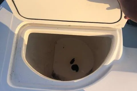 Slide: The Image of Open storage compartment on a 1999 Boston Whaler Outrage 26 boat. - 26