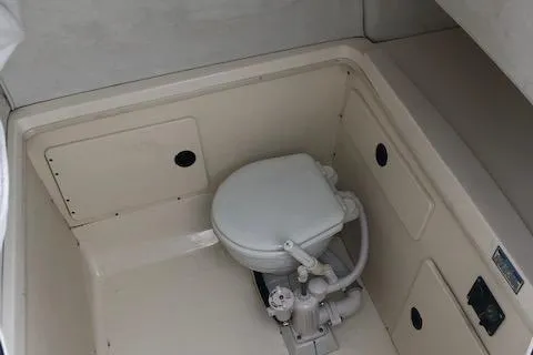 Slide: The Image of Interior of a 1999 Boston Whaler Outrage 26 with toilet. - 27