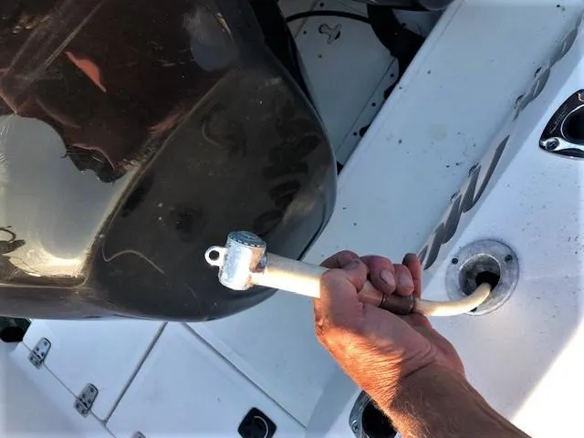 Slide: The Image of Hand holding boat key on 1999 Boston Whaler Outrage 26. - 28