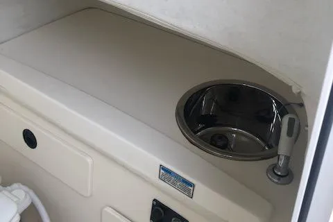 Slide: The Image of Interior of 1999 Boston Whaler Outrage 26 with sink. - 29