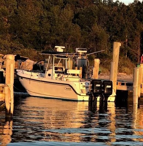 Slide: The Image of 1999 Boston Whaler Outrage 26 boat docked at sunset. - 3