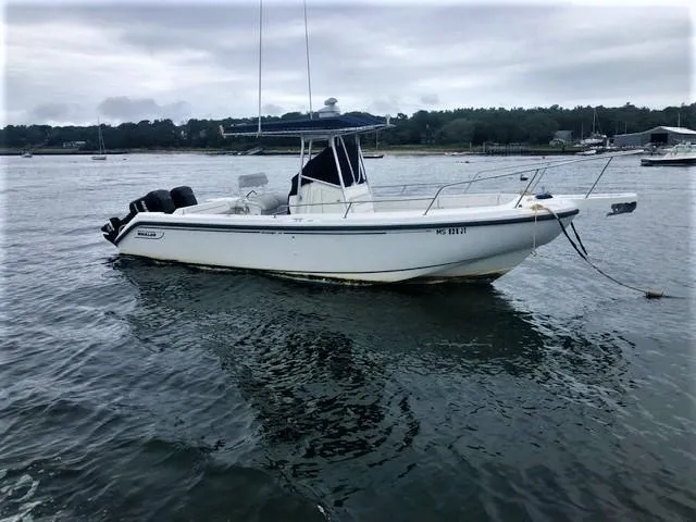 Slide: The Image of 1999 Boston Whaler Outrage 26 anchored on calm waters. - 4