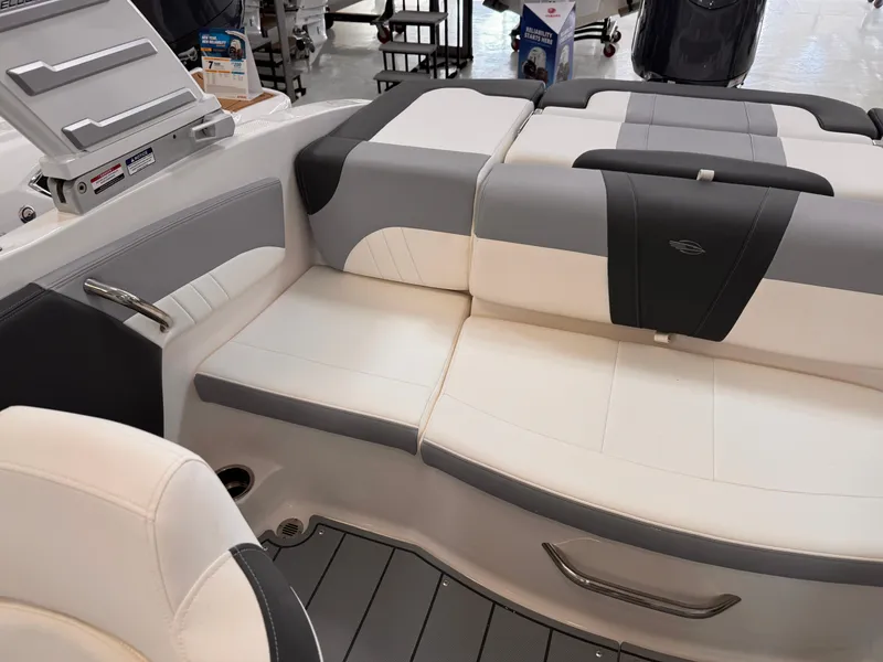 Slide: The Image of 2026 Chaparral 21 SSi OB boat interior with cushioned seating and outboard motor. - 17