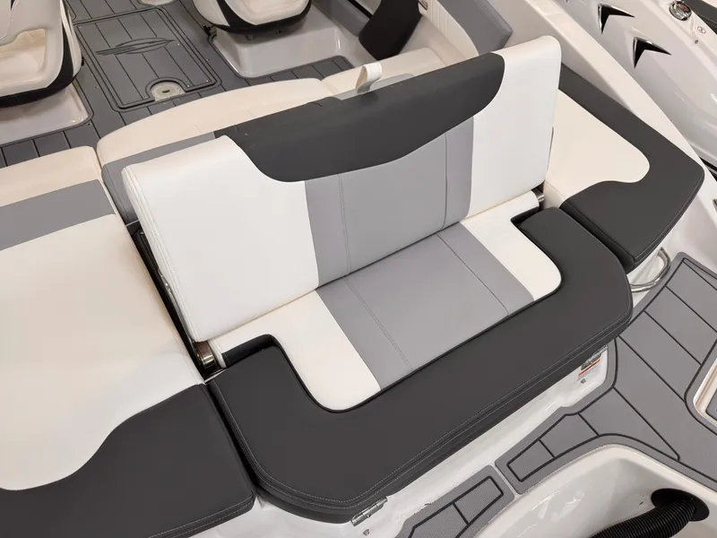 Slide: The Image of 2026 Chaparral 21 SSi OB boat interior with open storage compartments and cushioned seating. - 19
