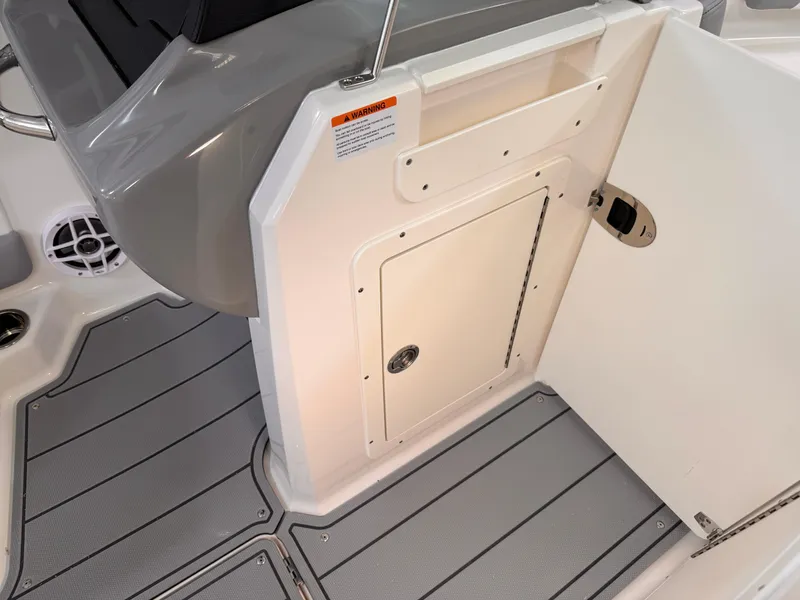 Slide: The Image of 2026 Chaparral 21 SSi OB boat interior with gray and white seating, near blue wall. - 8