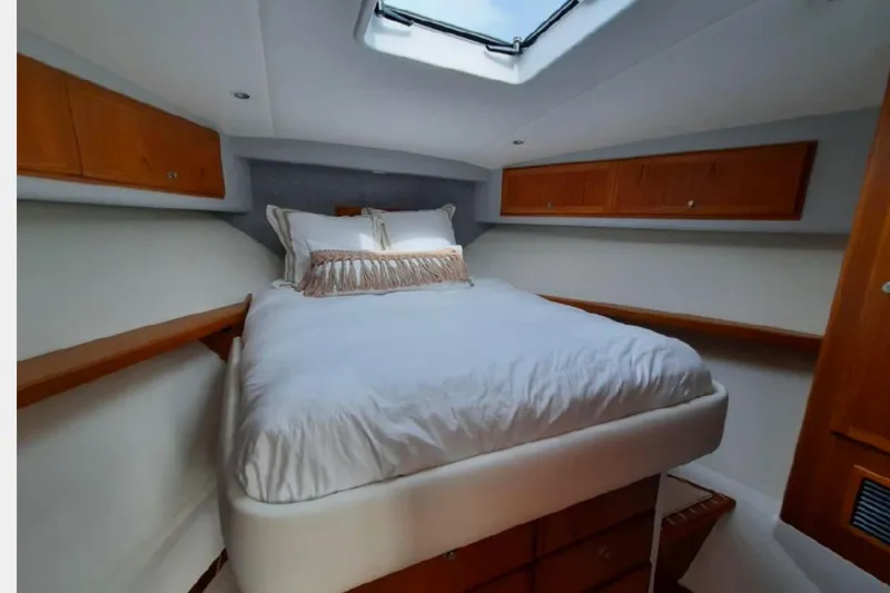 Slide: The Image of Luxurious cabin interior of 2020 Mag Bay 42 yacht with cozy bed and wooden storage. - 11