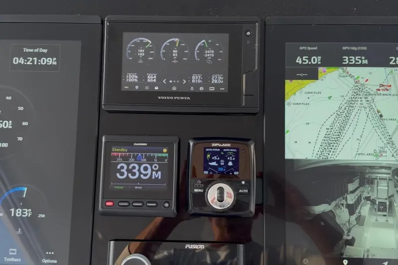 Slide: The Image of Dashboard of a 2020 Mag Bay 42 boat with navigation and engine displays. - 13