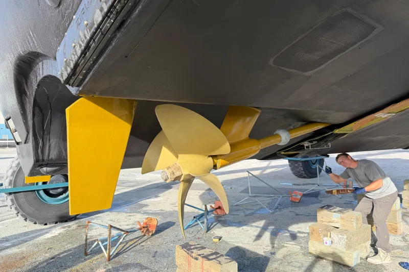 Slide: The Image of Man working on the propeller of a 2020 Mag Bay 42 boat. - 15