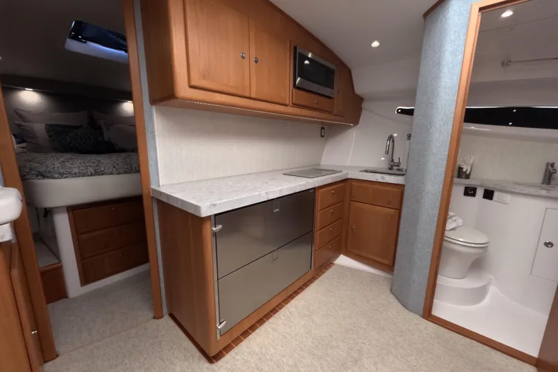 Slide: The Image of Luxurious interior of a 2020 Mag Bay 42 yacht featuring a modern kitchen and cozy bedroom. - 27