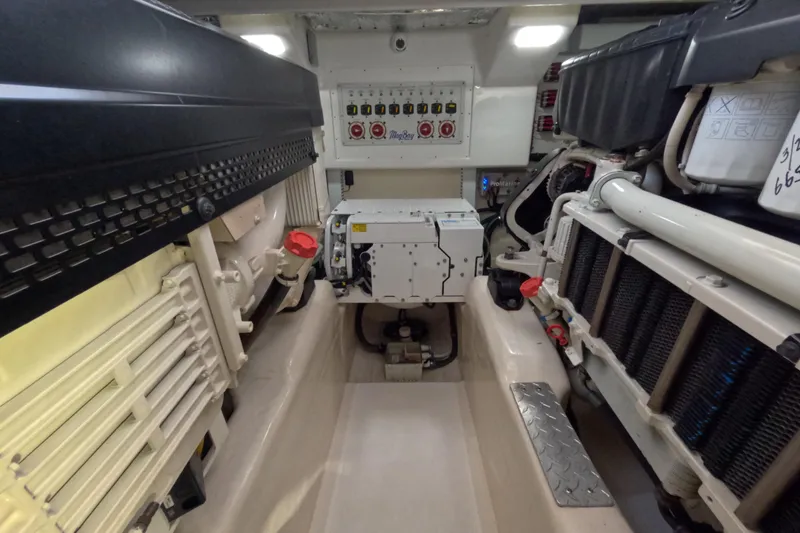 Slide: The Image of Engine room of a 2020 Mag Bay 42 boat, showcasing mechanical components and control panel. - 28