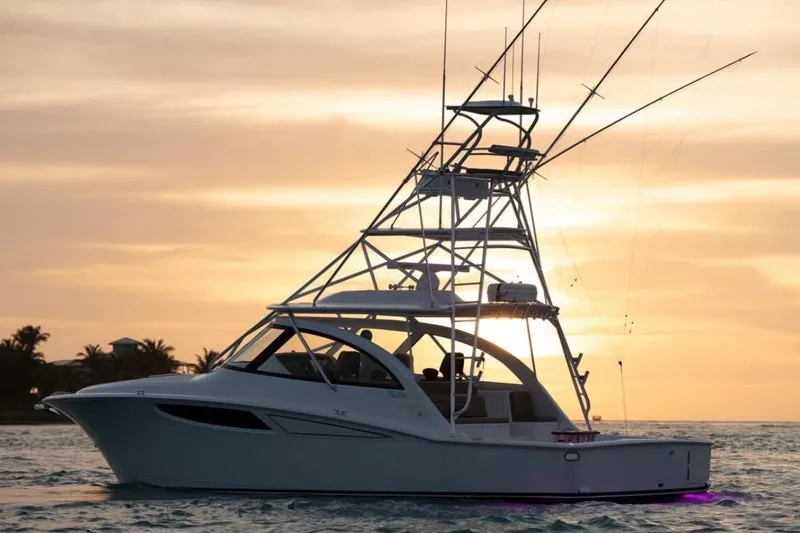 Slide: The Image of 2020 Mag Bay 42 yacht at sunset, silhouetted against a vibrant sky. - 29