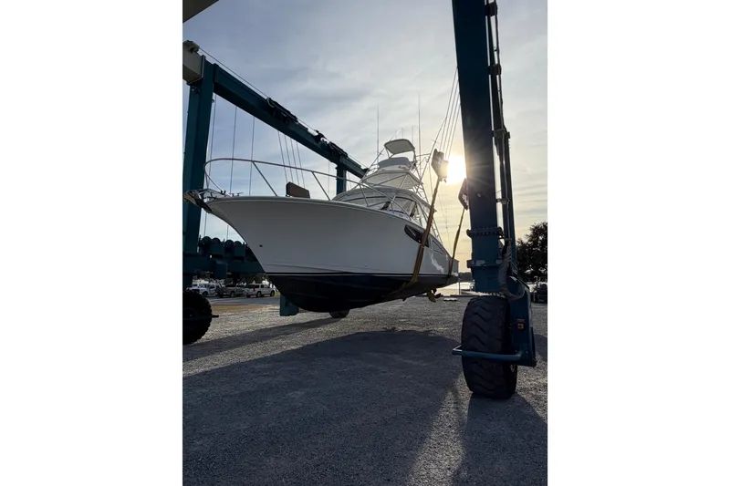 Slide: The Image of 2020 Mag Bay 42 boat lifted by crane at sunset. - 31