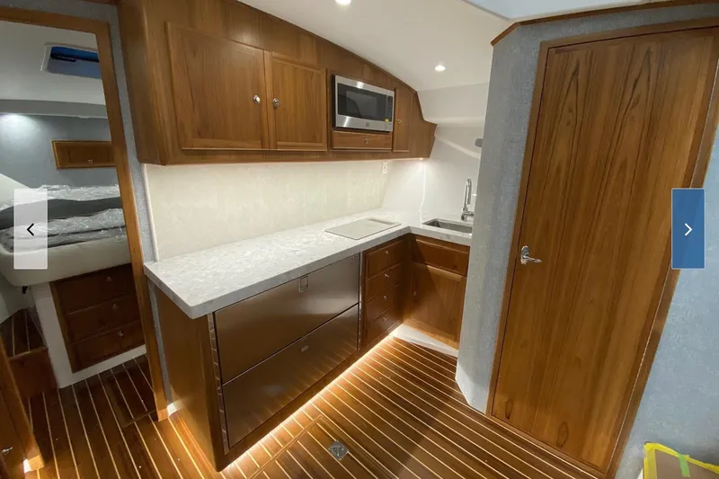 Slide: The Image of Luxurious 2020 Mag Bay 42 yacht interior with modern kitchen and wooden cabinetry. - 7