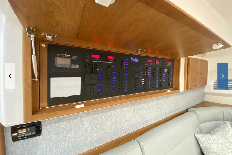 Slide: The Image of Electrical control panel inside a 2020 Mag Bay 42 boat, featuring Cummins Onan generator. - 8