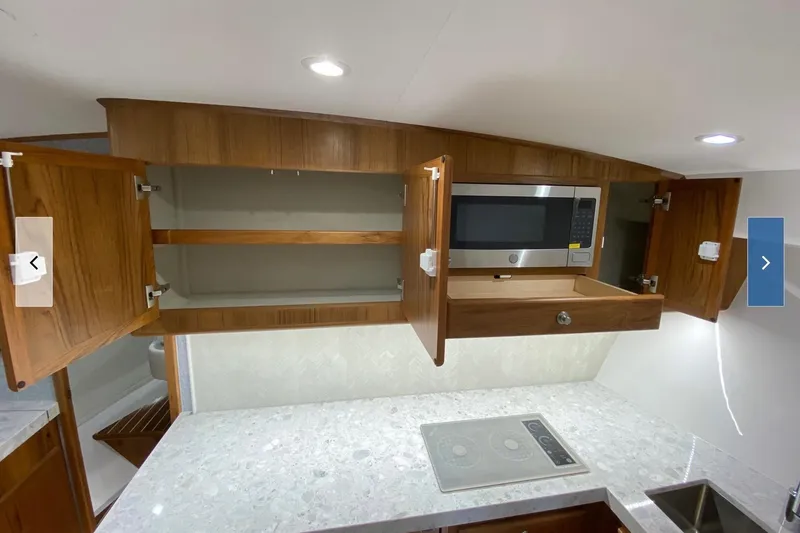 Slide: The Image of Modern kitchen in 2020 Mag Bay 42 yacht with microwave and sleek cabinetry. - 9