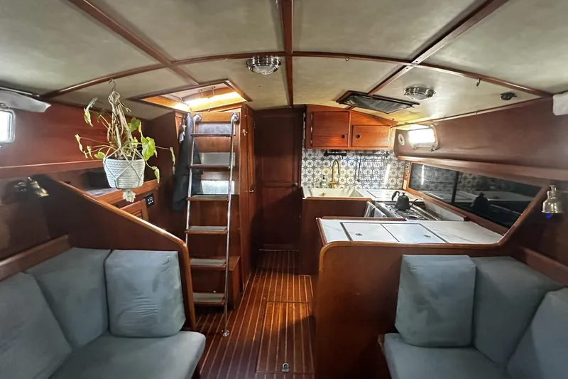 Slide: The Image of Interior of a 1981 Pearson 424 sailboat with wooden finishes and cozy seating. - 13