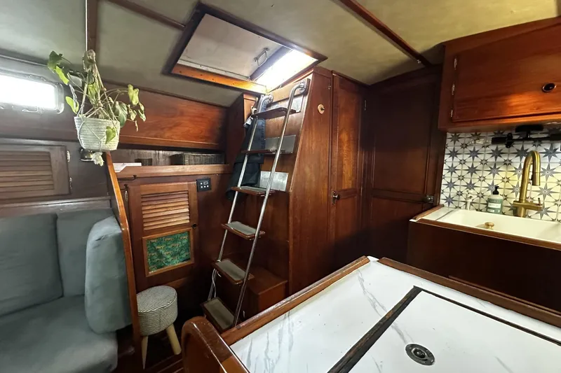 Slide: The Image of Interior of a 1981 Pearson 424 sailboat with wooden cabinetry and nautical decor. - 14