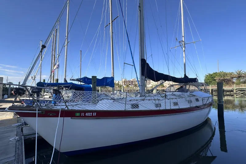 Slide: The Image of 1981 Pearson 424 sailboat docked at marina under clear blue sky. - 2