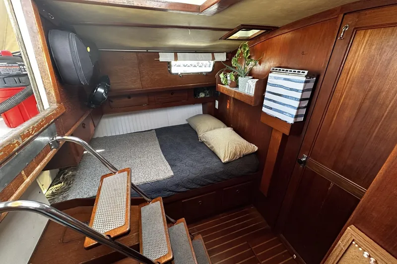Slide: The Image of Cozy cabin interior of 1981 Pearson 424 sailboat with wooden finish and bedding. - 27