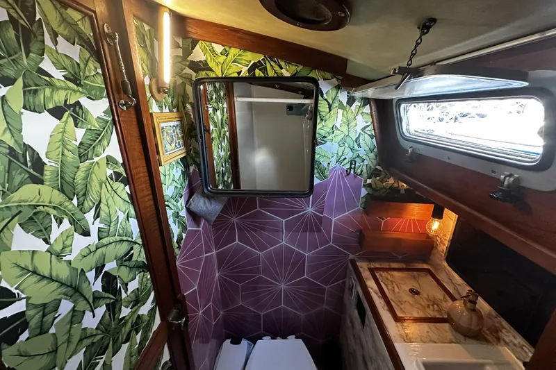 Slide: The Image of 1981 Pearson 424 yacht bathroom with tropical wallpaper and geometric accents. - 31