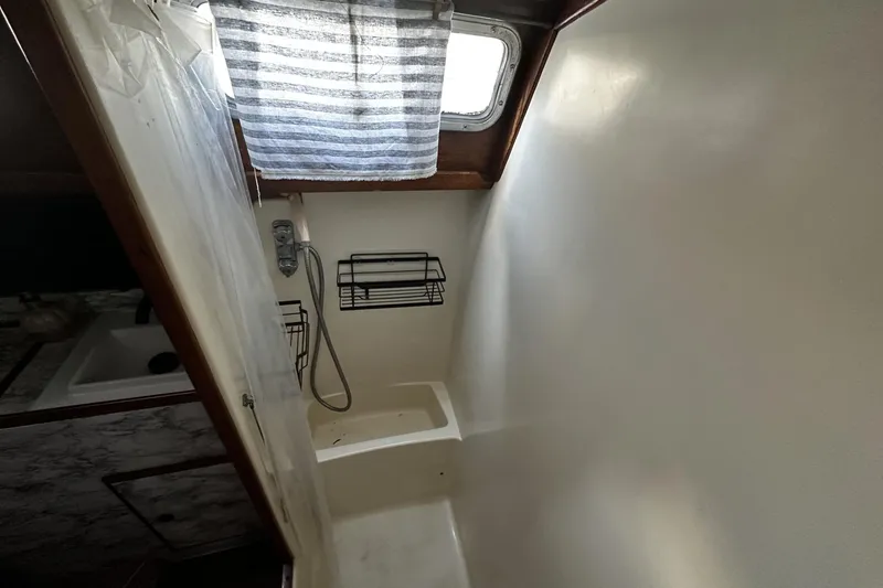 Slide: The Image of Interior of 1981 Pearson 424 sailboat bathroom with shower and window. - 32