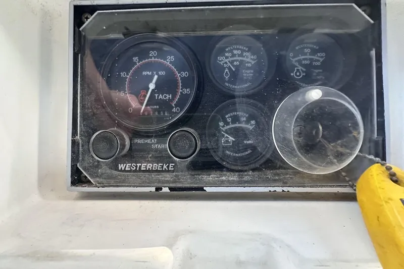 Slide: The Image of Westerbeke engine control panel on a 1981 Pearson 424 sailboat, featuring tachometer and gauges. - 34