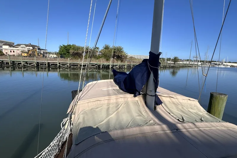 Slide: The Image of 1981 Pearson 424 sailboat docked in calm marina waters under clear blue sky. - 39