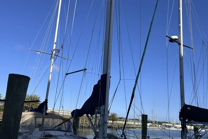 Slide: The Image of Sailboat masts of a 1981 Pearson 424 against a clear blue sky at a marina. - 40