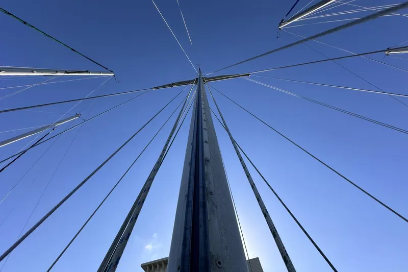 Slide: The Image of Looking up at the mast and rigging of a 1981 Pearson 424 sailboat against a clear blue sky. - 41