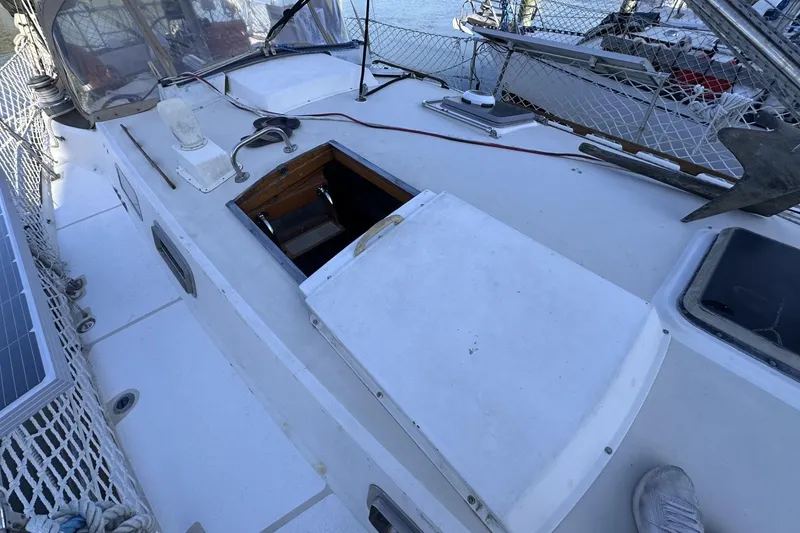 Slide: The Image of 1981 Pearson 424 sailboat deck with open hatch and solar panel. - 6
