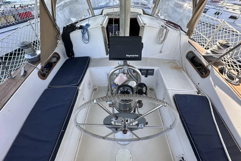 Slide: The Image of Cockpit of a 1981 Pearson 424 sailboat with steering wheel and navigation equipment. - 9