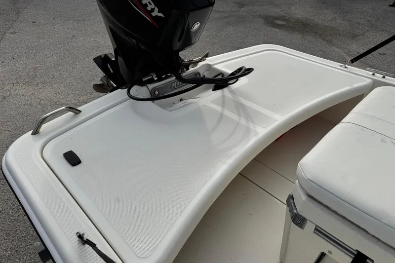 Slide: The Image of 2022 Mako Pro Skiff 15 CC boat with Mercury outboard motor, rear deck view. - 14