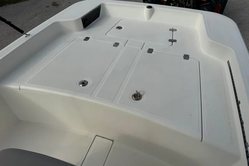 Slide: The Image of 2022 Mako Pro Skiff 15 CC boat deck with storage compartments. - 17