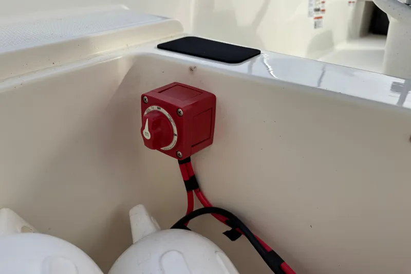 Slide: The Image of Red battery switch on 2022 Mako Pro Skiff 15 CC boat interior. - 19
