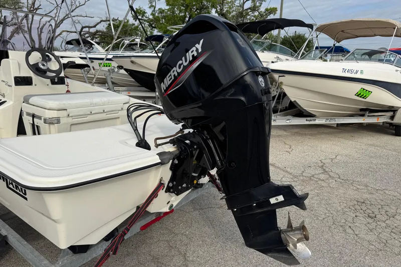 Slide: The Image of 2022 Mako Pro Skiff 15 CC with Mercury outboard motor, parked on a trailer. - 4