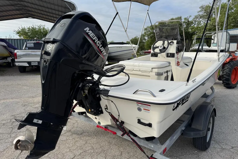 Slide: The Image of 2022 Mako Pro Skiff 15 CC boat with Mercury outboard motor on trailer. - 6