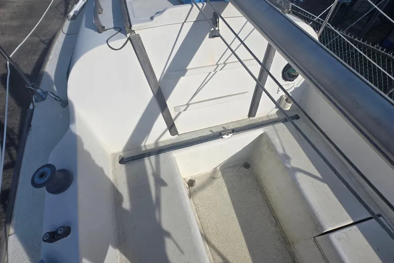 Slide: The Image of 1986 Sovereign 24 sailboat cockpit with winch, ropes, and seating area. - 10