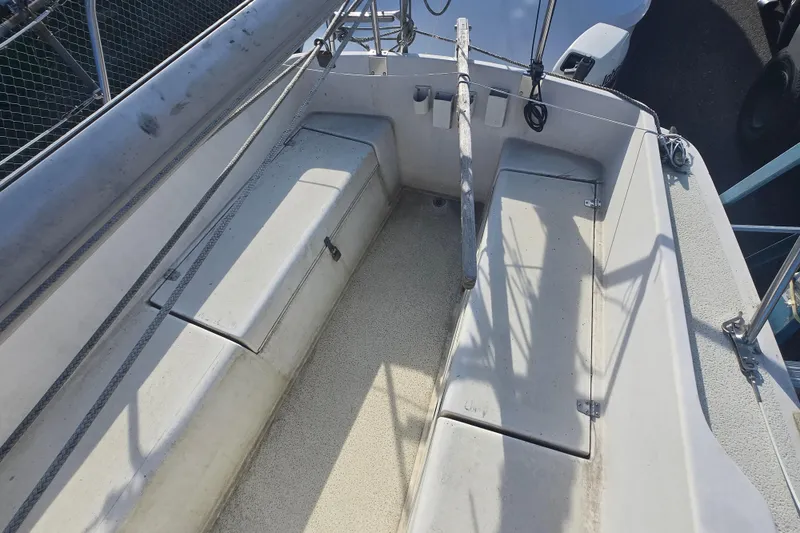 Slide: The Image of Cockpit of a 1986 Sovereign 24 sailboat, featuring storage compartments and rigging. - 15