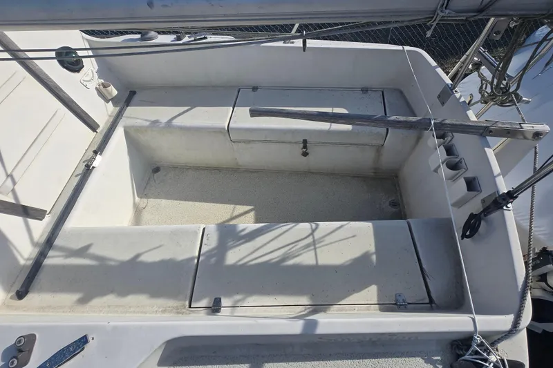 Slide: The Image of Cockpit of a 1986 Sovereign 24 sailboat, featuring seating and storage compartments. - 22
