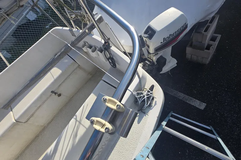 Slide: The Image of 1986 Sovereign 24 sailboat with Johnson outboard motor, docked and secured. - 23