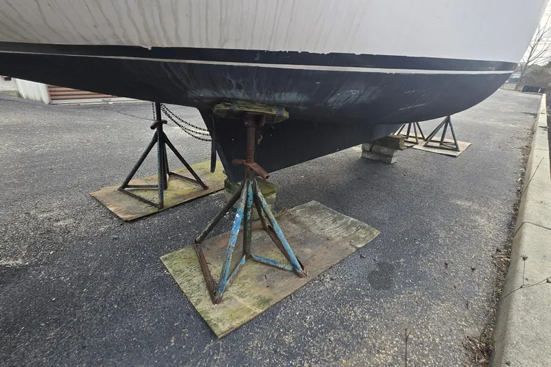 Slide: The Image of 1986 Sovereign 24 sailboat hull supported by stands on pavement. - 4
