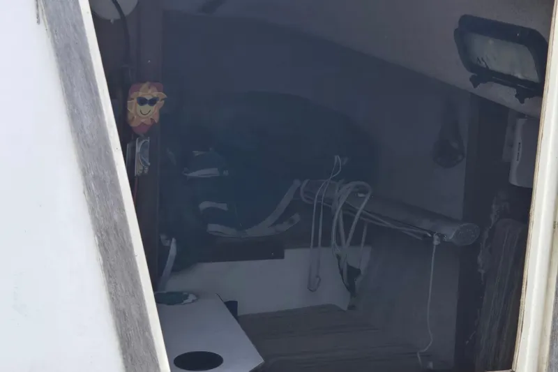 Slide: The Image of Interior view of a 1986 Sovereign 24 sailboat cabin with nautical equipment. - 7