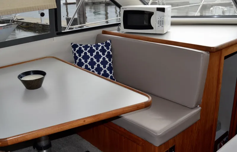 Slide: The Image of Interior of 1994 Carver 370 Voyager with table, seating, and microwave. - 15