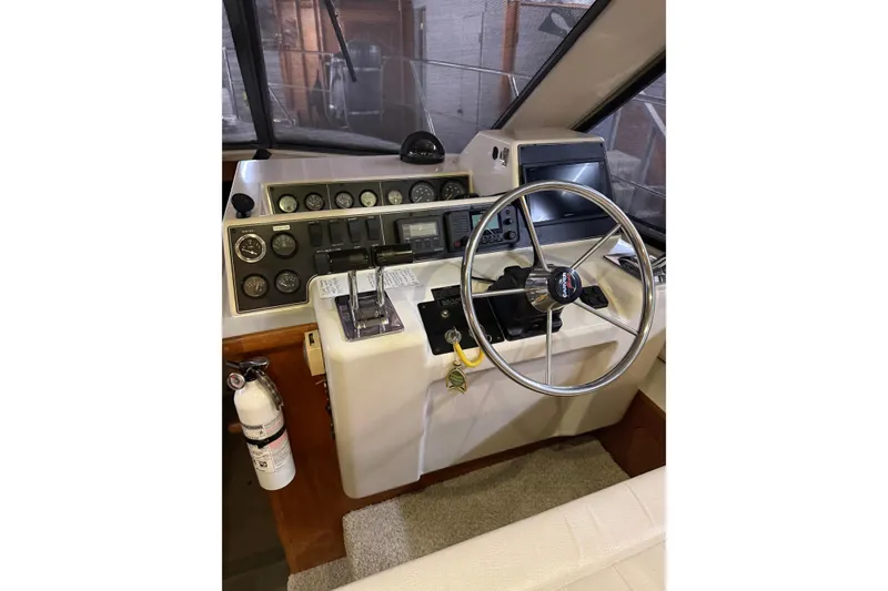 Slide: The Image of 1994 Carver 370 Voyager helm with steering wheel, gauges, and navigation equipment. - 17