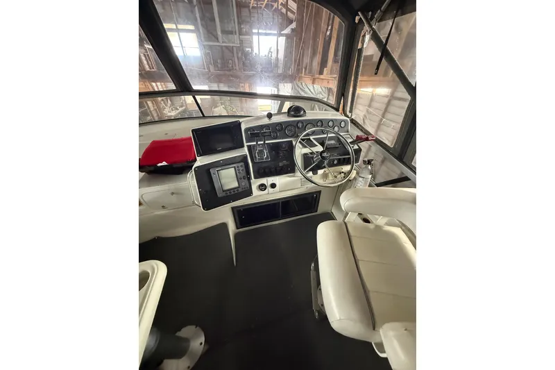 Slide: The Image of 1994 Carver 370 Voyager helm with steering wheel, gauges, and navigation equipment. - 2