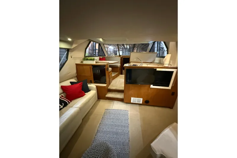 Slide: The Image of Interior of 1994 Carver 370 Voyager yacht with cozy seating and modern amenities. - 25